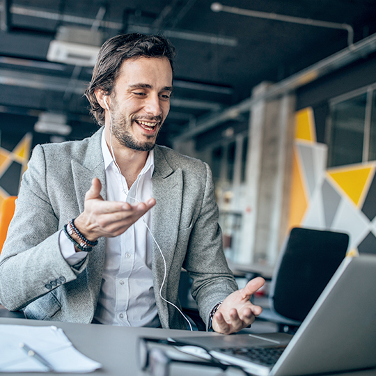 man speaking to a laptop