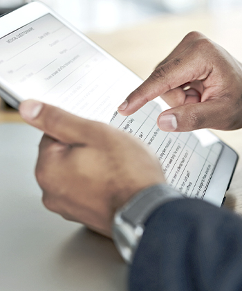 finger touching tablet screen